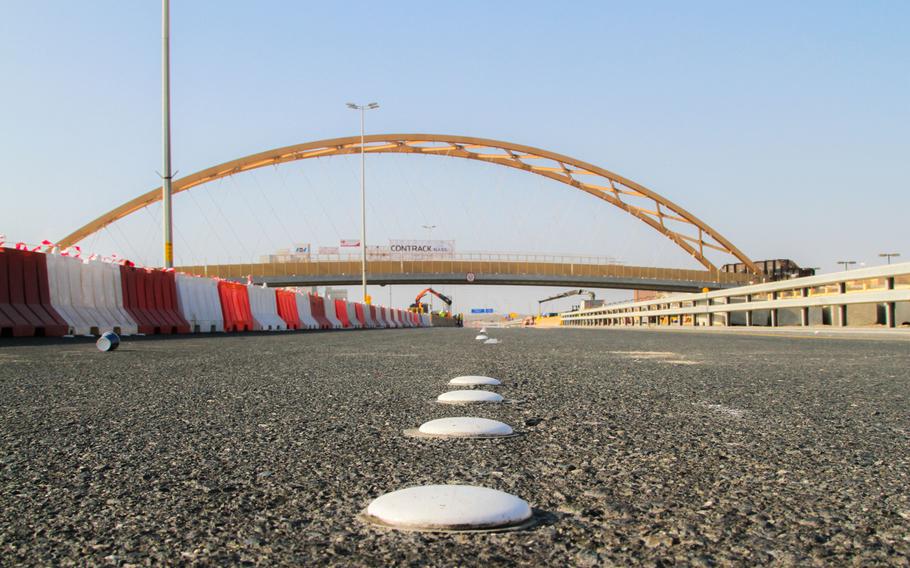 Workers finished moving an approximately 400-foot long tied-arch suspension flyover bridge Jan. 31, 2014, connecting Naval Support Activity Bahrain to the U.S. Navy port facility that comprises of 77 acres of land the Navy leases along the waterfront.