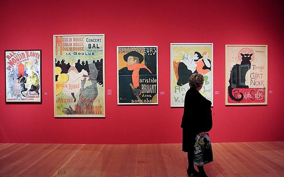 A visitor checks out posters by Jules Chéret, left, Henri de Toulouse-Lautrec and Th'ophile-Alexander Steinlen, right, at the "Esprit Montmartre: Bohemian Life in Paris around 1900" exhibit at the Schirn Kunsthalle in Frankfurt, Germany, Thursday, Feb. 6, 2014.