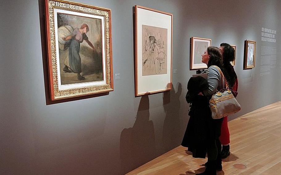 Visitors take a look at Henri de Toulouse-Lautrec's undated "La Blanchisseuse" at the "Esprit Montmartre: Bohemian Life in Paris around 1900" exhibit at the Schirn Kunsthalle in Frankfurt, Germany, Thursday, Feb. 6, 2014. At left is Thophile-Alexander Steinlen's work of the same name from 1895.