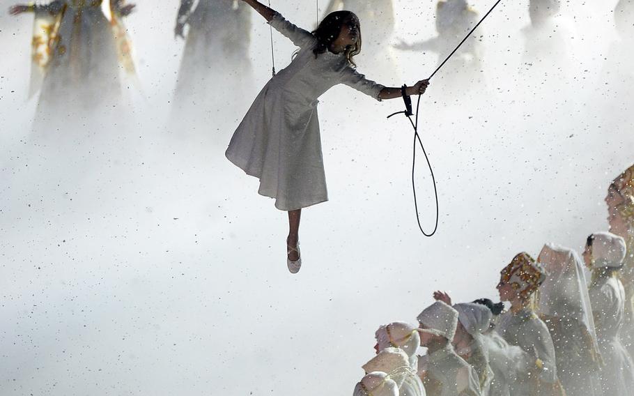 "Lubov" (Love), the main character featured in the Opening Ceremony of the 2014 Winter Olympics, is suspended over performers in classic Russian costumes at Fisht Olympic Stadium in Sochi, Russia, Friday, Feb. 7, 2014. (Chuck Myers/MCT)