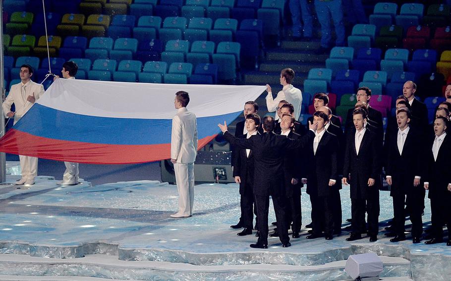 The Russian national anthem and the raising of the Russian flag take place during the Opening Ceremony for the Winter Olympics at Fisht Olympic Stadium in Sochi, Russia, Friday, Feb. 7, 2014. (Chuck Myers/MCT)