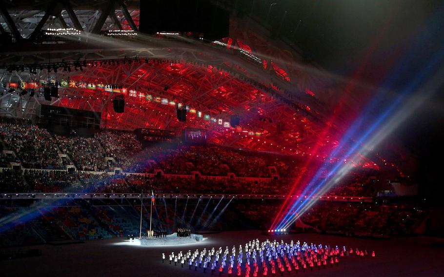 Performers in red, white and blue illuminated costumes form the Russian national flag during the Opening Ceremony for the Winter Olympics at Fisht Olympic Stadium in Sochi, Russia, Friday, Feb. 7, 2014. (Brian Cassella/Chicago Tribune/MCT)