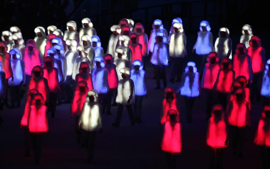 Performers costumed in illuminated red, white and blue outfits prepare to form the Russian national flag during the Opening Ceremony for the Winter Olympics at Fisht Olympic Stadium in Sochi, Russia, Friday, Feb. 7, 2014. (Brian Cassella/Chicago Tribune/MCT)