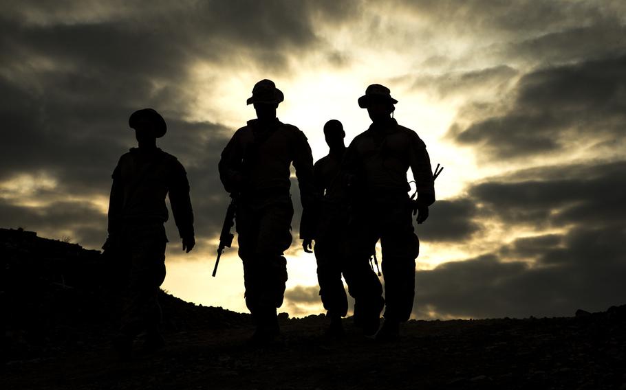 U.S. Marines with the 13th Marine Expeditionary Unit head home after practice drills during a platoon assault exercise at Arta Range, Djibouti, on Feb. 10, 2014.