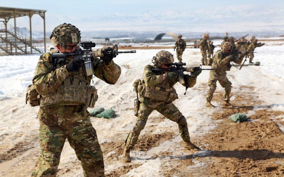 Capt. Jason Gillespie, left, 1st Sgt. Casey McFall, middle, and 1st Lt. Maurice Coopers take part in live-fire range training with M4 carbines on Forward Operating Base Lightning in Afghanistan's Paktiya province, on Feb. 14, 2014.