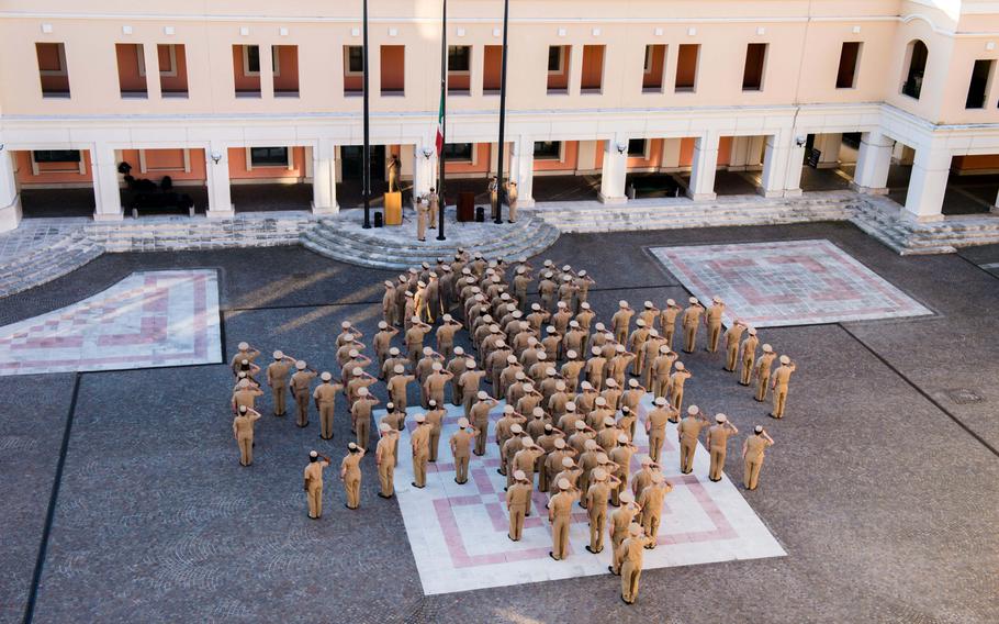 Naples area chief petty officers create an anchor with ''USN'' across it while in formation for morning colors at U.S. Naval Support Activity Naples, Italy, to celebrate the 121st birthday of the Navy chief petty officer April 1, 2014.