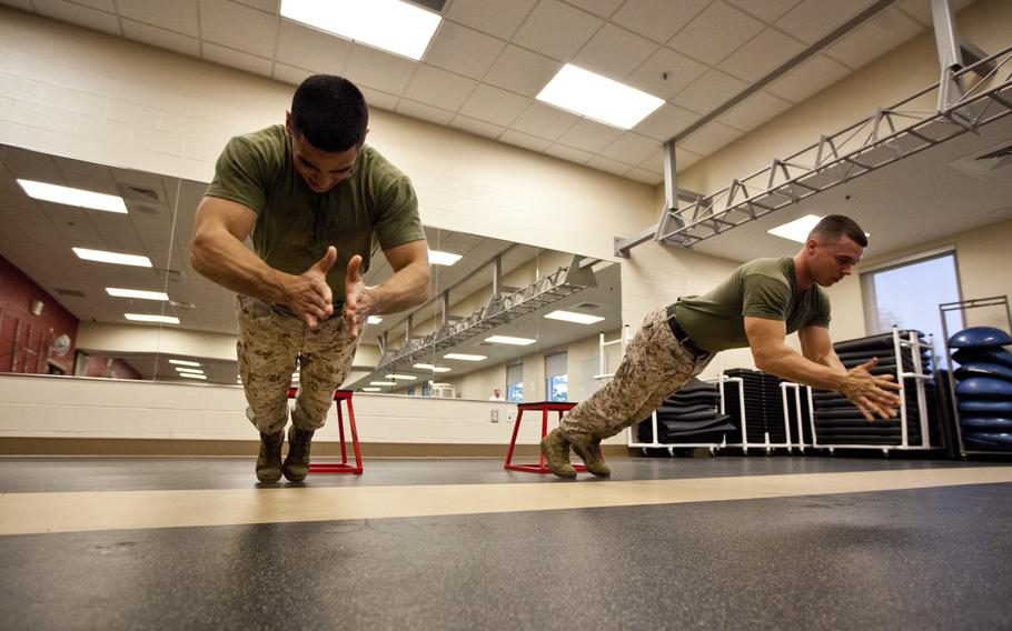 Cpl. Fabian Reynoso, right, and Cpl. Joshua Caldwell execute clap push-ups as part of the High Intensity Tactical Training program aboard Marine Corps Air Station Beaufort, S.C., on April 4, 2013.