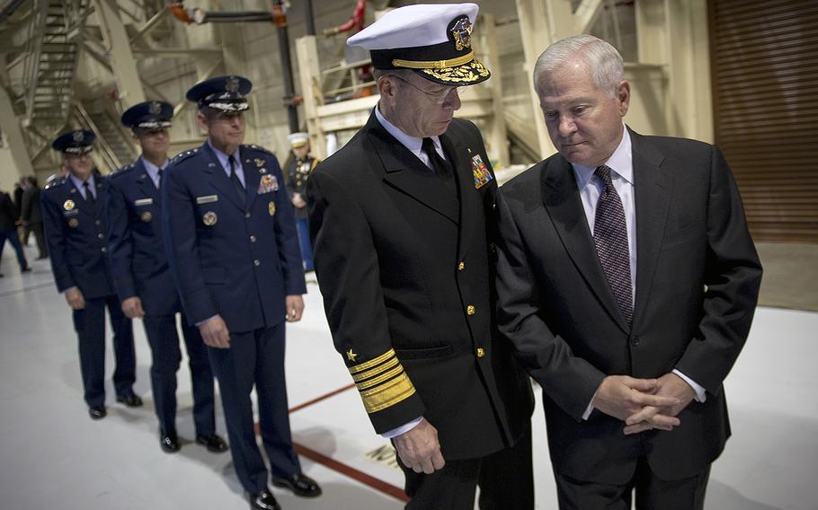Adm. Mike Mullen, then-chairman of the Joint Chiefs of Staff, speaks with Secretary of Defense Robert M. Gates prior to the U.S. Strategic Command Change of Command ceremony on Jan. 28, 2011. 