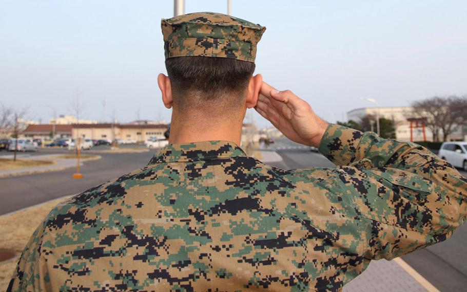 Pfc. Mansure, whose identity is being withheld by Stars and Stripes due to safety concerns regarding his family still living in Iraq, salutes the flag in front of the Marine Corps Air Station Iwakuni headquarters building in February. Mansure beat the odds and through hard work, perseverance and a little bit of luck, went from an Iraqi translator helping the Americans and dodging terrorist threats in his native Iraq to an American citizen and a United States Marine.