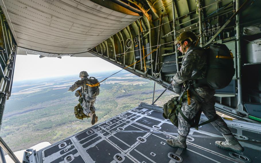 U.S. Air Force Tactical Air Control Party airmen wait to jump from a C-130H Hercules aircraft on April 3, 2014, over Sylvania, Ga. Airmen and soldiers from the Georgia Air and Army National Guard trained together for two days jumping at different location.