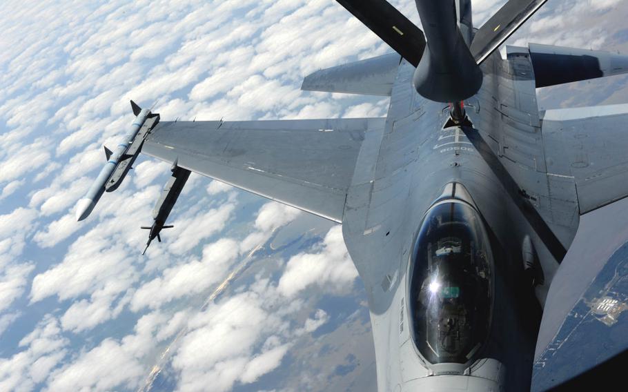 An F-16 Fighting Falcon refuels over the Florida panhandle, on Wednesday, April 16, 2014, during a training exercise. A McConnell Air Force Base, Kansas., KC-135 Stratotanker crew assisted F-22 Raptors from Tyndall Air Force Base, Florida, and F-16s from Hill Air Force Base, Utah, during their mission. 