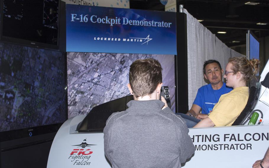 A girl tries out the realistic F-16 cockpit demonstrator at the USA Science and Engineering Festival on April 25, 2014 in Washington, D.C.