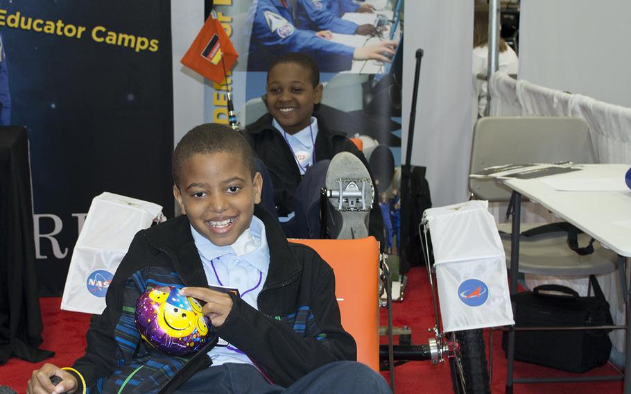 Young boys drive a piece of equipment from NASA during the USA Science and Engineering Festival on April 25, 2014 in Washington, D.C.