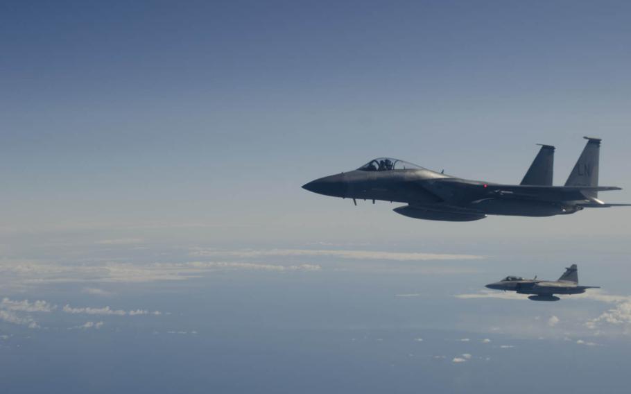 An F-15C Eagle and a Swedish JAS-39 Gripen Fighter fly in formation during a training event over the Baltic Sea on Tuesday, April 1, 2014. Airmen and F-15Cs from RAF Lakenheath, England, deployed to Lithuania in early January to assume the Baltic Air Policing mission.