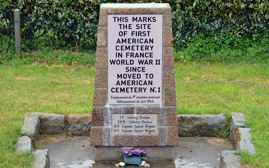 A small monument on Omaha Beach on the edge of  Vierville-sur-Mer (look for house number 156) marks where the first American cemetery in France in World War II was once located. The bodies were later relocated.