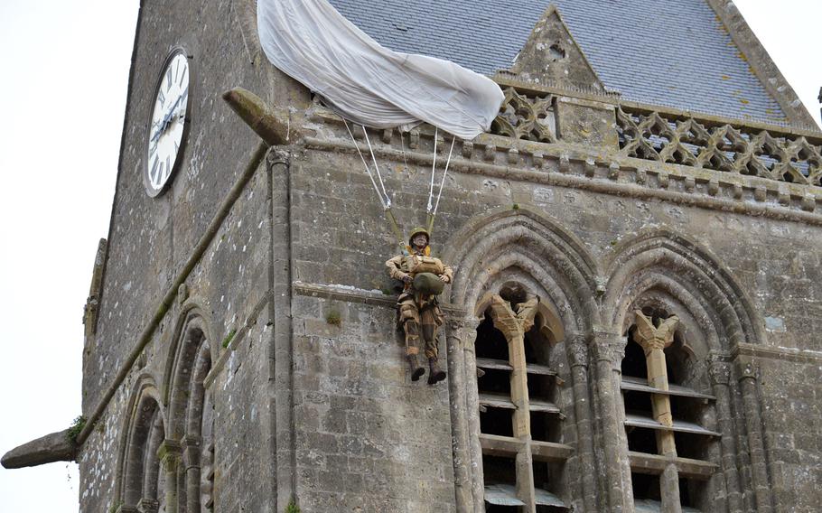 An effigy of Pvt. John Steele, an 82nd Airborne Division soldier, hangs from the steeple at the Ste.-Mère-Église church. Steele's parachute got caught on the steeple when he jumped on D-Day. He played dead for several hours, but eventually was taken prisoner by the Germans. He later escaped and continued to fight in the war. His plight was retold in the1962 movie "The Longest Day," where he was played by Red Buttons.