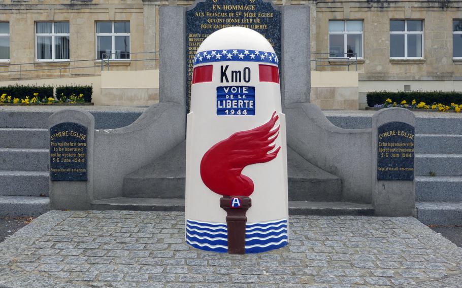 A post marking Kilometer 0 of the Voie de la Liberté, or Liberty Road, stands in front of the Ste.-Mère-Église town hall. The route follows the Americans' drive across France to liberate the country in World War II. Interestingly, there is a Kilometer 00 marker at Utah Beach, as well.