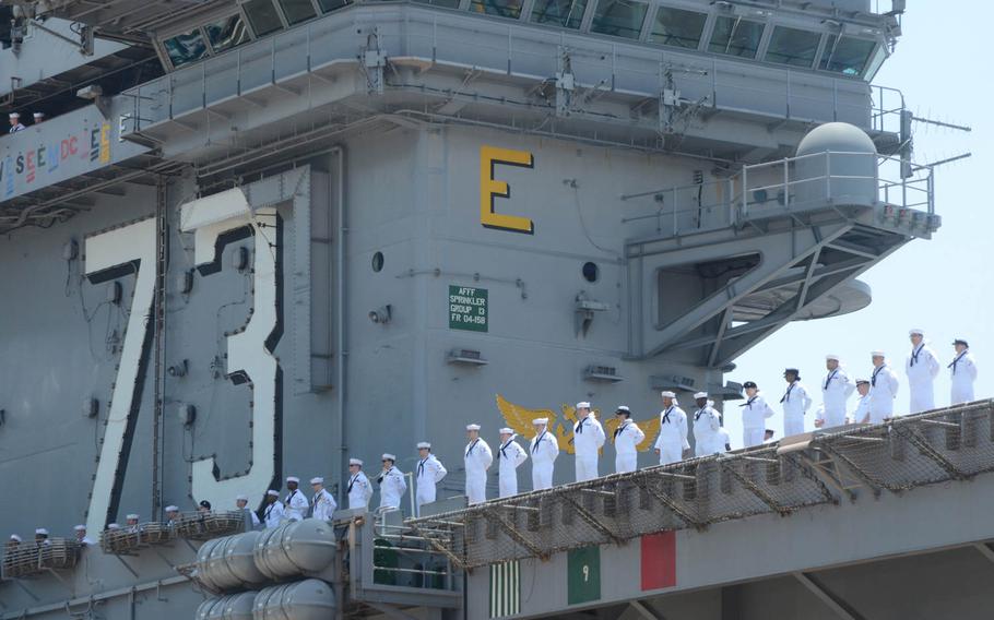 Sailors aboard the aircraft carrier USS George Washington prepare to depart Yokosuka Naval Base on May 24, 2014. The ship embarked on its scheduled patrol of the Pacific Ocean.
