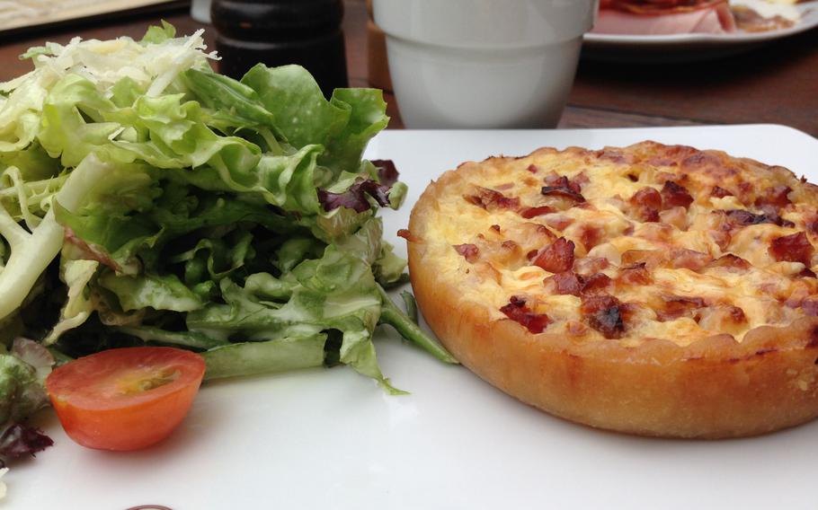 At La Maison du Pain in Wiesbaden, Germany, the quiche Lorraine is served warm with a zesty ham-and-onion filling and comes with a light salad topped with a creamy vinaigrette dressing.