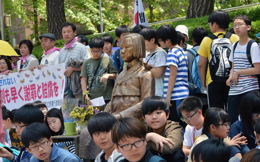 Korean protesters sit around the Pyeonghwa-bi, Peace Monument, across the Japanese Embassy in Seoul, South Korea, on May 21, 2014. A protest is held every Wednesday over the issue of Korean women forced into sexual slavery by Japan during World War II.