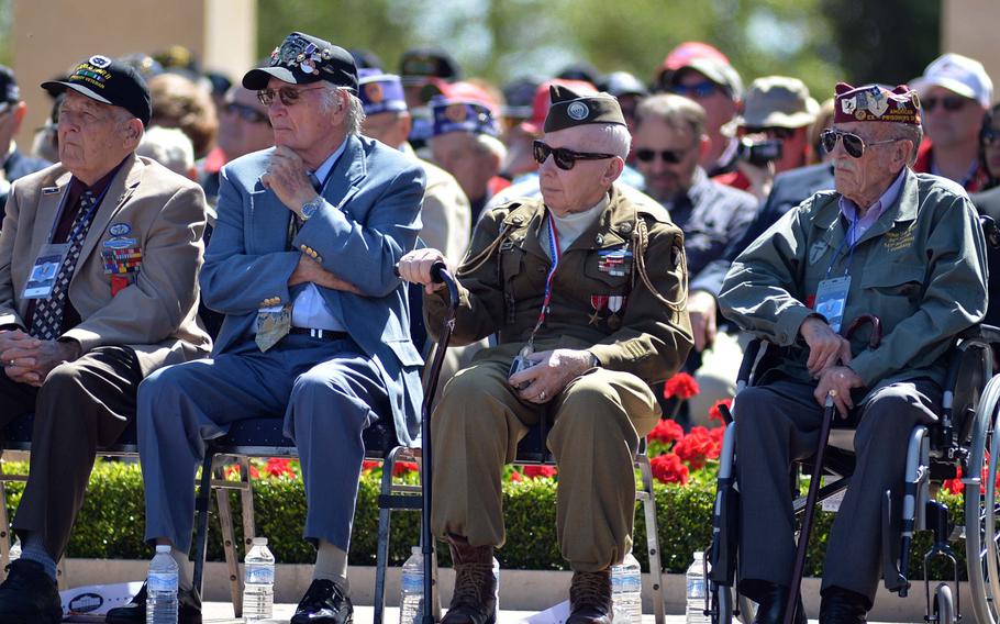World War II veterans listen to President Barack Obama speak at the ceremony at Normandy American Cemetery in Colleville-sur-Mer, on June 6, 2014, marking the 70th anniversary of D-Day.