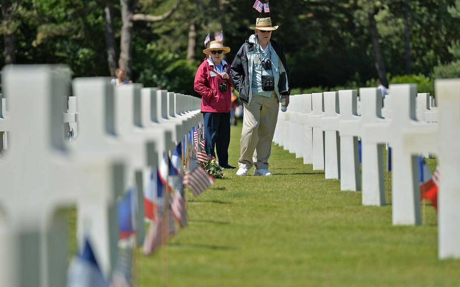 Susan and Robert McLellan of Andover, Maine, look at the grave markers following the ceremony at Normandy American Cemetery in Colleville-sur-Mer, June 6, 2014, marking the 70th anniversary of D-Day.