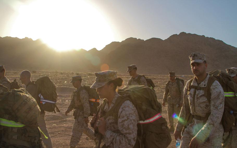 U.S. Marines from Command Element Marine Forces Central Commandfinsh the final mile of a 4 mile hike as the sun rises over the mountains near Aqaba, Jordan, June 6.