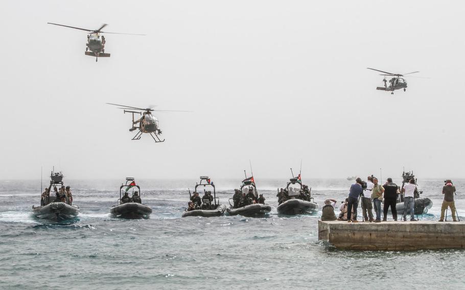 Multinational Special Forces on helicopters and inflatable boats position themselves for a photo-op after conducting a sea-based assault on a target ashore during a demonstration to the media and civilian observers at Eager Lion in Jordan, June 5.