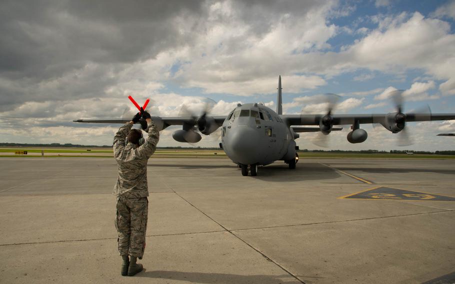 U.S. Air Force Tech. Sgt. Nick Kozar, crew chief, 94th Airlift Wing, Dobbins Air Reserve Base, Georgia, marshals in a C-130H Hercules aircraft during the Maple Flag exercise in Edmonton/Cold Lake, Alberta, Canada, on Tuesday, May 27, 2014.