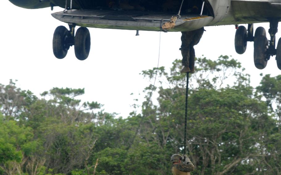 Marines with 3rd Reconnaissance Battalion perform a simple fast-rope technique before moving on to more difficult skills during fast rope training in northern Okinawa, June 17, 2014.