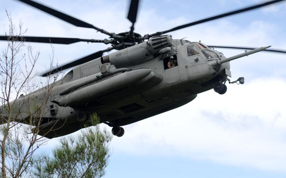 A CH-53 Super Stallion flies in for a quick fast rope drop during fast rope training in northern Okinawa, June 17, 2014.