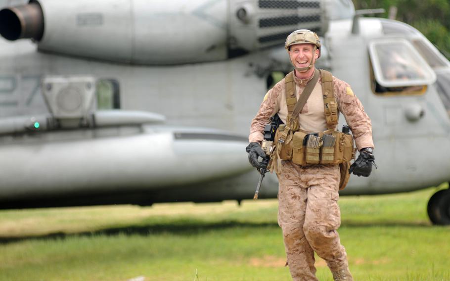 A 3rd Reconnaissance Battalion Marine can't help but grin during fast-rope training in northern Okinawa, June 17, 2014.