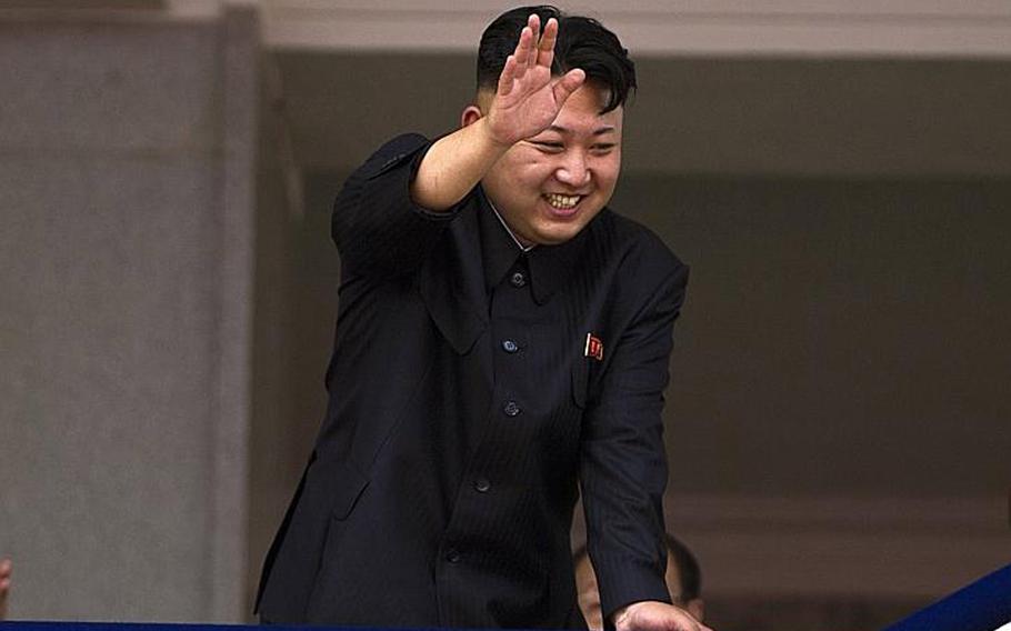 North Korean leader Kim Jong Un waves to Korean War veterans on parade in Kim Il Sung Square in Pyongyang in this undated photo. North Korea is warning that the release of a new American comedy about a plot to assassinate leader Kim Jong Un would be an 'act of war.'