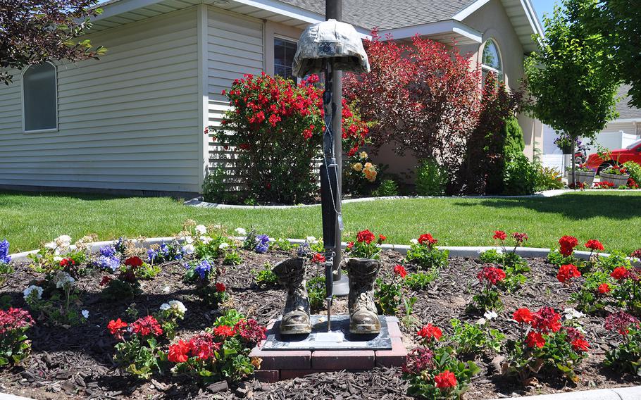 A battlefield cross stands in the yard of Jerry and Becky Brown, whose son, Army Staff Sgt. Daniel Brown, was killed by a roadside bomb in Afghanistan on March 24, 2012. The cross elicits little attention in the suburban subdivision where they live in Twin Falls, Idaho.