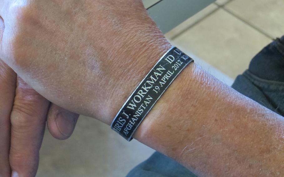 John Workman wears a memorial bracelet in honor of his late son, Sgt. Chris Workman, who died at age 33 in a helicopter crash in southern Afghanistan on April 19, 2012.