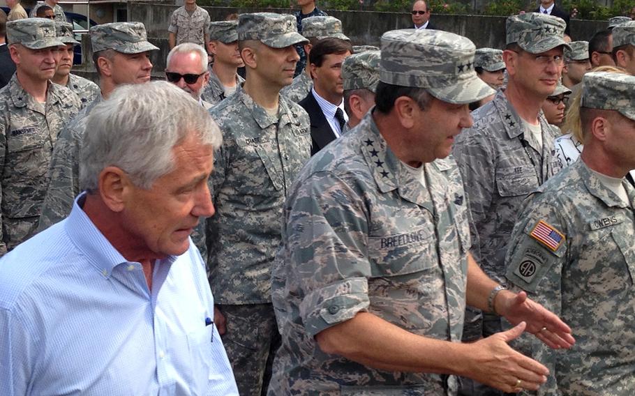 Defense Secretary Chuck Hagel, left, and EUCOM commander Gen. Philip Breedlove, center, talk with troops  Wednesday, Aug. 6, 2014 at U.S. European Command headquarters in Stuttgart, Germany. Hagel met with Breedlove and conducted a brief town hall session with servicemembers.