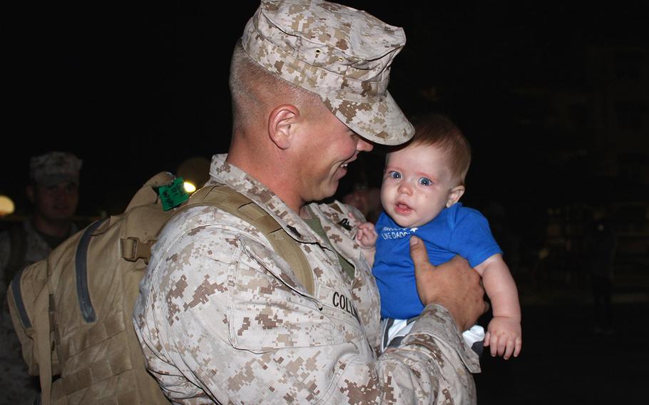 Cpl. Nickolas Collins meets his son, 6-month-old Karson Collins, for the first time Wednesday morning at Camp Pendleton, Calif. Collins returned early Wednesday from a seven-month deployment to Camp Leatherneck, Afghanistan, with Tango Battery, 5th Battalion, 11th Marine Regiment. Collins' wife, Annette Collins, made a sign saying, "I've waited my whole life to meet you" and dressed Karson in American flag-themed shorts and a shirt printed with "Awesome like daddy" for the occasion.