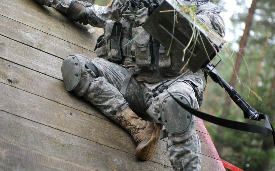 U.S. Army Sgt. Timothy Jenkins, assigned to Company A, 1st Battalion, 4th Infantry Regiment, overcomes an obstacle during the Joint Multinational Training Command?s Best Warrior Competition at Grafenwoehr Training Area, Germany, Aug. 12, 2014.