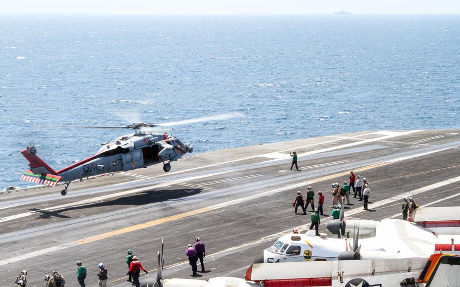 An SH-60 Seahawk helicopter lands aboard the USS George H.W. Bush during a deployment in the Persian Gulf, Aug. 11, 2014.