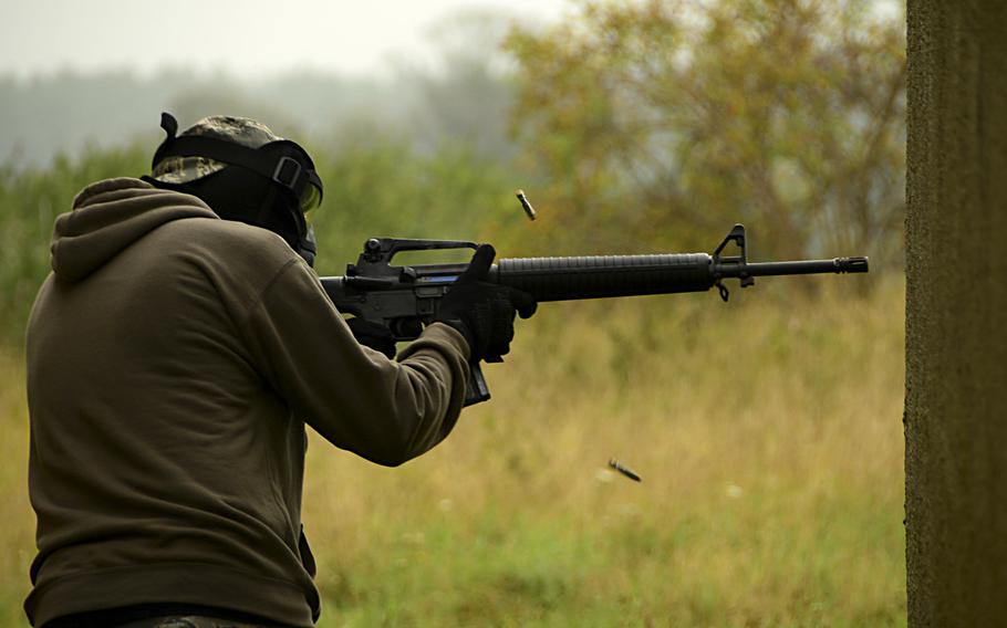 An airman from the 48th Mission Support Group fires an M-16 assault rifle during a force-on-force exercise at Stanford Training Area, England.