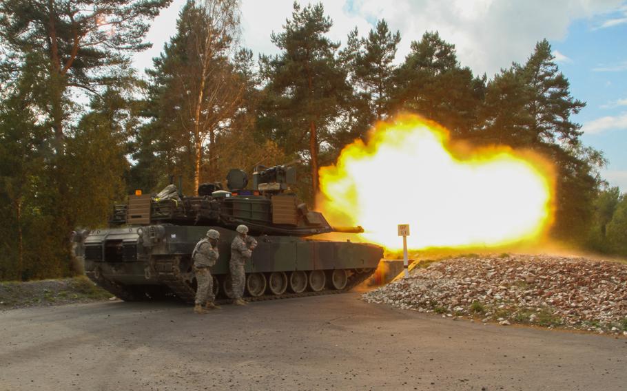 Sgt. 1st Class Joseph Maughon, right, and Staff Sgt. Scott Colson remote fire a tank during calibration fire at the Grafenwoehr Training Area, Germany, Oct. 1, 2014.