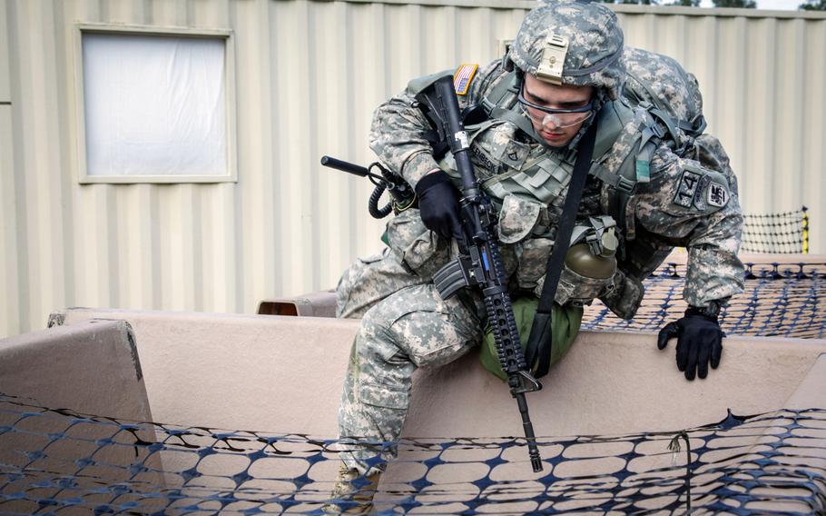 U.S. Army Pvt. Brian Hollenbeck, representing the U.S. Army Africa, participates in the Close Quarters Battle exercise in the annual Best Warrior competition in Fort Lee, Va., Oct. 7, 2014.