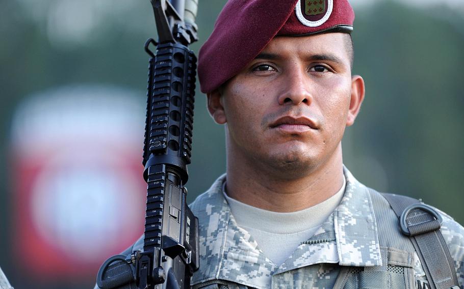 A 1st Brigade Combat Team, 82nd Airborne Division, paratrooper and member of the Division color guard stands at attention on Fort Bragg, N.C.?s Pike Field during the division's change of command ceremony, Oct. 3, 2014.