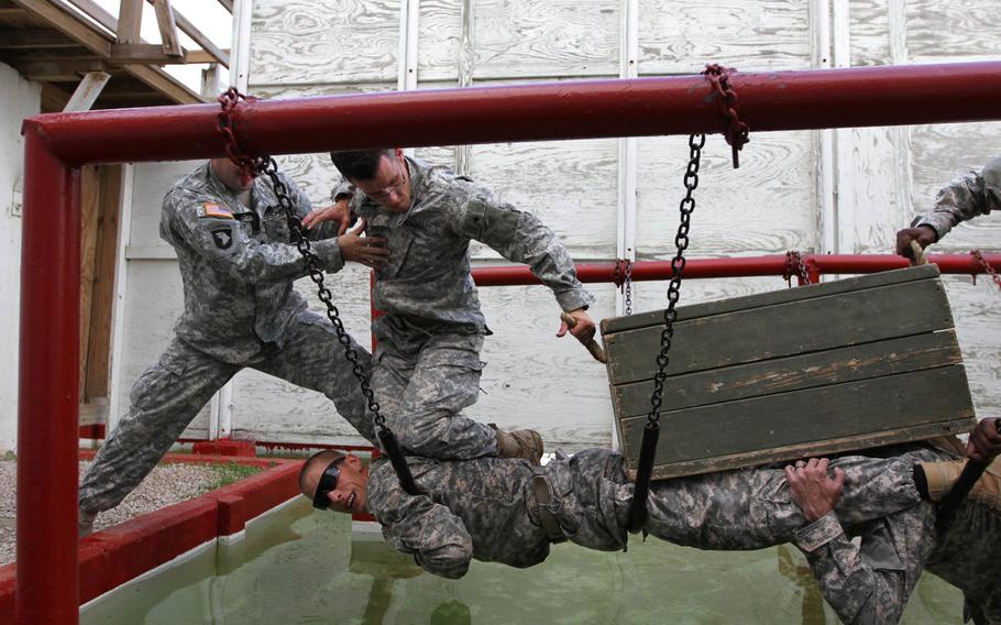 Warrior Diplomat Soldiers from 85th Civil Affairs Brigade use teamwork to negotiate obstacles at the Leaders Reaction Course at Fort Hood, Texas, on Oct. 9, 2014.