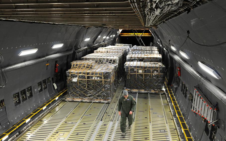 A Reserve airman from the 512th Airlift Wing delivers humanitarian supplies to Nicaragua aboard a C-5M Supergalaxy on Dec. 20, 2014. Some 125,000 pounds of food and educational equipment were airlifted to Nicaragua's Augusto C. Sandino International Airport in Managua.