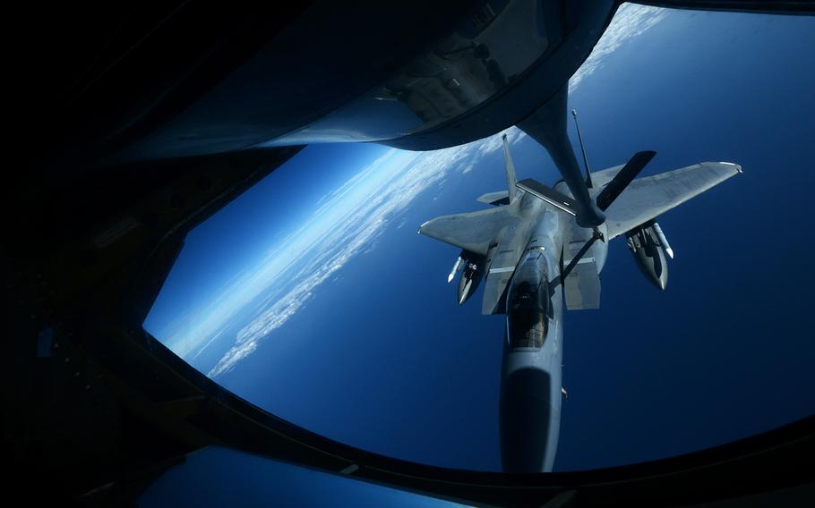 A U.S. Air Force KC-135 Stratotanker from the 909th Air Refueling Squadron refuels an F-15C Eagle near Okinawa, Japan, on Dec. 23, 2014.