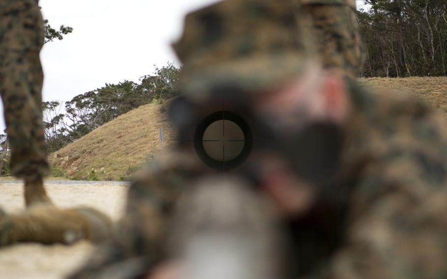 A Marine sights in with an M110 semi-automatic sniper system, acquainting himself with the unloaded weapon during marksmanship/observer training on Range 22 on Jan. 6, 2015, on Camp Bulter, Okinawa.