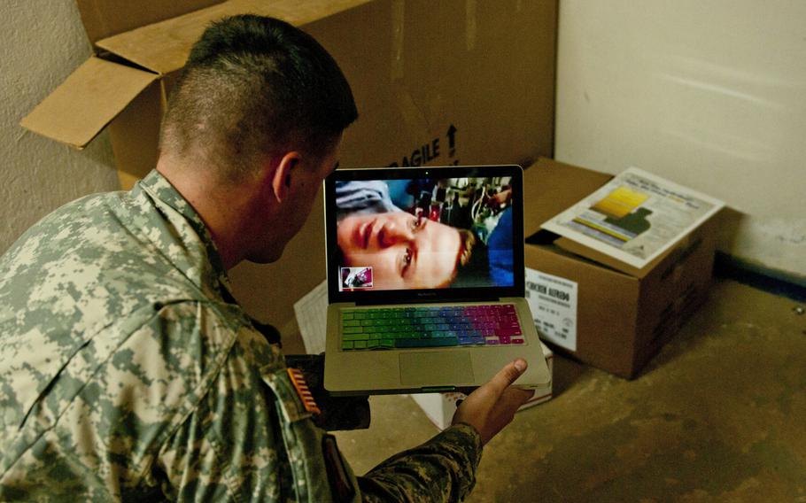 Cpl. Daniel Sutton, movement noncommissioned officer for the 62nd Engineer Battalion, 36th Engineer Brigade, currently deployed to Paynesville, Liberia, in support of Operation United Assistance, watches a live video feed of his wife, Rachael, give birth to their new son Jan. 8, 2015.