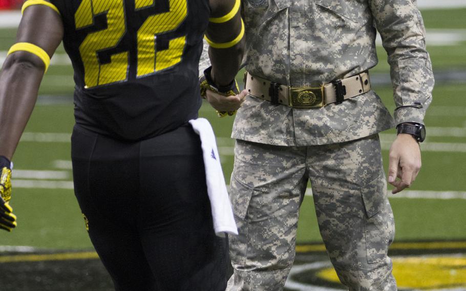 Army Reserve Drill Sgt. of the Year, Staff Sgt. Christopher Croslin, greets players during pre-game of the 2015 Army All-American Bowl, Jan. 3, 2015, in San Antonio, Texas.