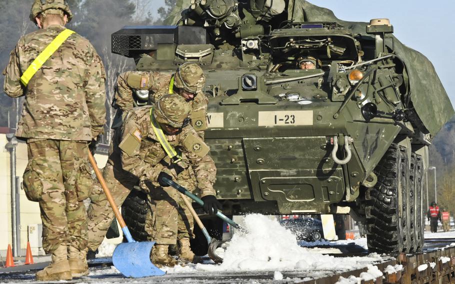 Dragoon Troopers assigned to 3rd Squadron, 2d Cavalry Regiment load Strykers to be transported by train as the unit moves to assume the lead in training with their multi-national partners and allies during Operation Atlantic Resolve at Rose Barracks, Germany, Jan. 6, 2015.